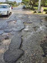 A potholes on a road

Description automatically generated