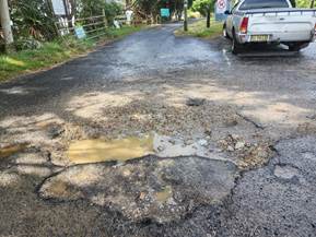 A pothole on a road

Description automatically generated