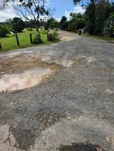 A road with a puddle on it

Description automatically generated