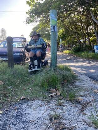 A person sitting on a scooter

Description automatically generated