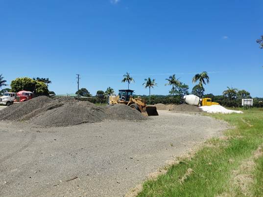 A construction site with a pile of gravel

Description automatically generated