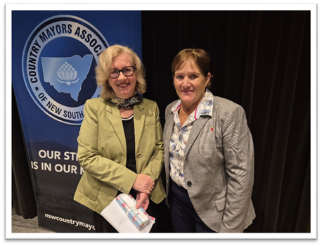 Mayor Sue Moore presents Ms Carmel Donnelly PSM with a thank you gift 